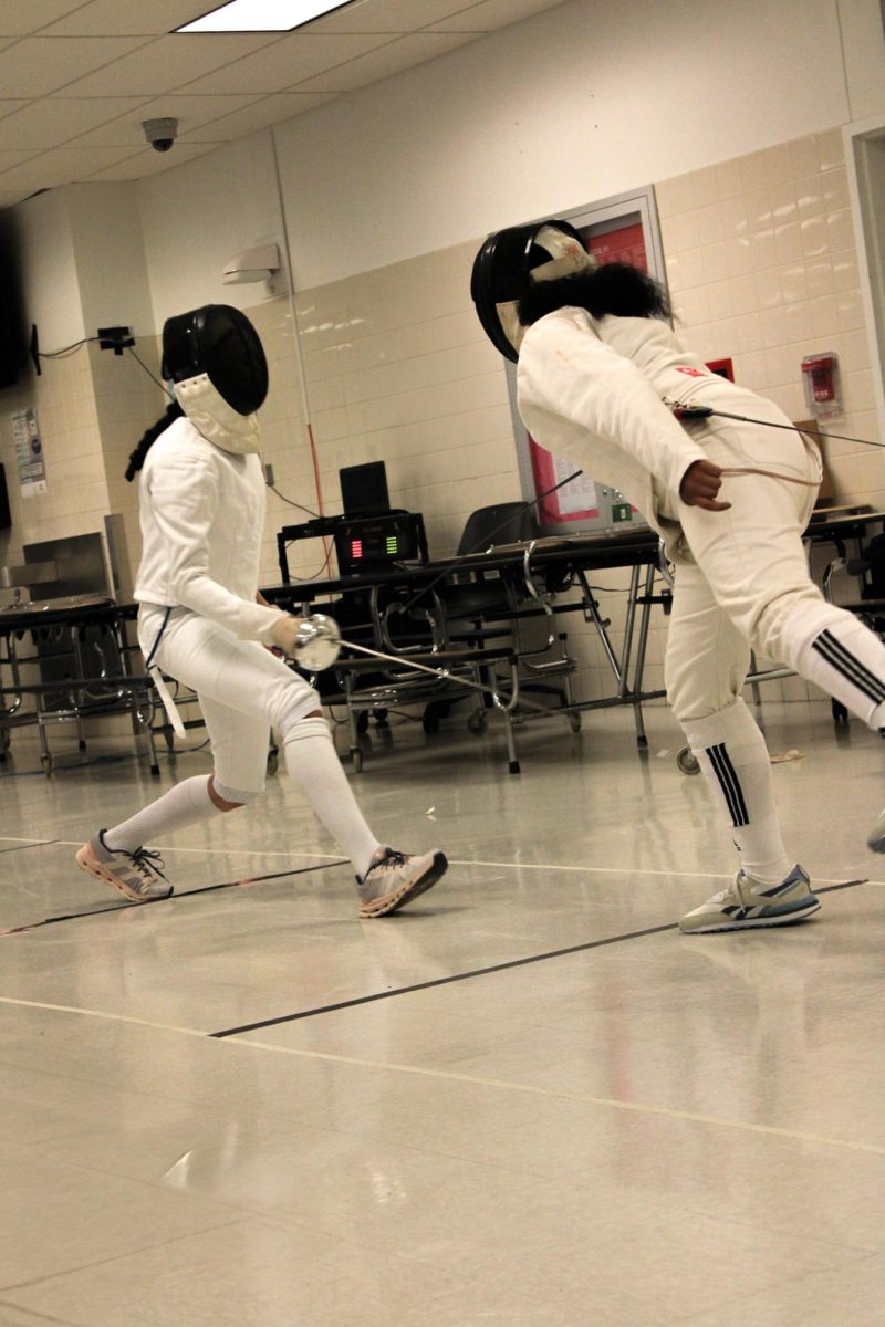 Julissa Polanco, a sophomore representing Art and Design, competing against Beacon High School on May 26, 2025. She skillfully defends herself against her opponent's attack.